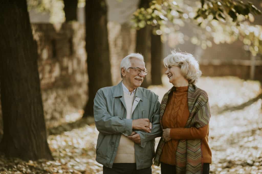 Senior couple walking in autumn park